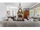 Spacious living room with a stone fireplace, elegant chandelier, and comfortable seating at 140 Discovery Lake Dr, Fayetteville, GA 30215