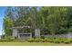 An entrance sign for The Canoe Club community, surrounded by manicured landscaping and a stone wall at 140 Discovery Lake Dr, Fayetteville, GA 30215
