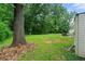 View of the backyard featuring mature trees and a seating area at 165 Wellington Dr, Mcdonough, GA 30252