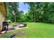 A delightful backyard features an outdoor seating area and well-maintained lawn at 165 Wellington Dr, Mcdonough, GA 30252