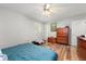 Bedroom showcasing hardwood floors, two windows, and a door at 165 Wellington Dr, Mcdonough, GA 30252