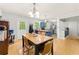 Dining area with hardwood floors, adjacent to a bright, open kitchen at 165 Wellington Dr, Mcdonough, GA 30252