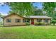 Charming brick home featuring a well-maintained lawn, trimmed shrubbery, and black shuttered windows at 165 Wellington Dr, Mcdonough, GA 30252