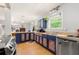 Well-lit kitchen features painted cabinets with new appliances and tile flooring at 165 Wellington Dr, Mcdonough, GA 30252