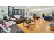 Open-concept living room featuring wood floors and a large cozy sofa at 165 Wellington Dr, Mcdonough, GA 30252