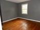 Bedroom with hardwood flooring, trim, and a bright window at 3083 Colonial Way # E, Atlanta, GA 30341