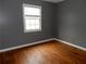 Cozy bedroom with hardwood floors, trim, and a bright window at 3083 Colonial Way # E, Atlanta, GA 30341