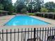 Large community pool featuring covered seating areas and a secure gated surround at 3083 Colonial Way # E, Atlanta, GA 30341