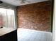 Bright sun room with brick accent wall and sliding glass door to the exterior at 3083 Colonial Way # E, Atlanta, GA 30341