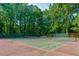 A well-maintained outdoor tennis court surrounded by lush greenery at 3083 Colonial Way # E, Atlanta, GA 30341