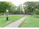 Manicured lawn and a walkway leading to the community's tennis and basketball courts at 3083 Colonial Way # E, Atlanta, GA 30341