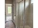 Bathroom with tiled shower, glass doors, and tile flooring at 344 Riverwood Pass, Dallas, GA 30157