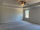 Calm bedroom showcasing plush carpeting and a tray ceiling with a ceiling fan at 344 Riverwood Pass, Dallas, GA 30157
