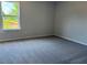 This bedroom offers neutral walls, plush carpeting and a window providing natural light at 344 Riverwood Pass, Dallas, GA 30157
