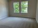 Inviting bedroom with carpet flooring and large windows at 344 Riverwood Pass, Dallas, GA 30157