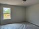 Cozy bedroom featuring a large window with natural light and neutral walls at 344 Riverwood Pass, Dallas, GA 30157