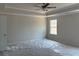 Spacious bedroom with carpet flooring, ceiling fan, tray ceiling, and a large window at 344 Riverwood Pass, Dallas, GA 30157