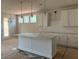 Modern kitchen with an island, white cabinets, and pendant lighting above island at 344 Riverwood Pass, Dallas, GA 30157