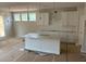 Modern kitchen with an island, white cabinets, and pendant lighting above island at 344 Riverwood Pass, Dallas, GA 30157