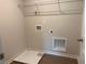 This laundry room offers vinyl flooring, a storage shelf, and access to water and dryer connections at 344 Riverwood Pass, Dallas, GA 30157