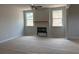 Spacious living room featuring two bright windows, a fireplace, and a ceiling fan at 344 Riverwood Pass, Dallas, GA 30157
