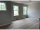 Spacious living room featuring three bright windows and neutral walls at 344 Riverwood Pass, Dallas, GA 30157