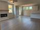 Open-concept living area connecting to kitchen and dining, featuring modern fireplace at 344 Riverwood Pass, Dallas, GA 30157