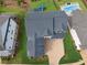 Aerial view of the home showing the driveway and a large roof, plus backyard with pool and playset at 4020 Connolly Ct, Roswell, GA 30075