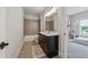 Tiled bathroom with large vanity and neutral color palette with view to adjacent bedroom at 4020 Connolly Ct, Roswell, GA 30075