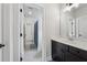 Well-lit bathroom featuring a dark vanity with modern fixtures and stylish blue-themed accents at 4020 Connolly Ct, Roswell, GA 30075