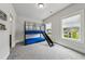 Cozy bedroom with a bunk bed featuring a slide, large windows, and neutral carpeting for a comfortable space at 4020 Connolly Ct, Roswell, GA 30075