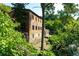 Picturesque exterior featuring a charming brick building nestled amidst lush greenery at 4020 Connolly Ct, Roswell, GA 30075