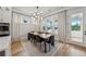 Bright dining room featuring a modern light fixture, large windows and natural light with access to the patio at 4020 Connolly Ct, Roswell, GA 30075