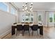 Bright dining room featuring a modern light fixture, large windows, and a stylish table set for six at 4020 Connolly Ct, Roswell, GA 30075