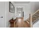 Welcoming foyer with hardwood floors, staircase, and bench seating at 4020 Connolly Ct, Roswell, GA 30075