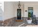 Charming porch with black rocking chair, brick accents, and beautiful door at 4020 Connolly Ct, Roswell, GA 30075
