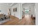 Bright hallway with hardwood floors and staircase with iron spindles at 4020 Connolly Ct, Roswell, GA 30075