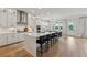 Bright, modern kitchen with white cabinets, stainless steel appliances, a large island and hardwood floors at 4020 Connolly Ct, Roswell, GA 30075