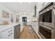 Modern kitchen with white cabinets, stainless steel appliances, and a large center island at 4020 Connolly Ct, Roswell, GA 30075