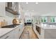 Spacious kitchen featuring white cabinetry, stainless steel appliances, gas cooktop, and a center island at 4020 Connolly Ct, Roswell, GA 30075