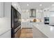 Modern kitchen featuring white cabinets, stainless steel appliances, and a center island with seating at 4020 Connolly Ct, Roswell, GA 30075