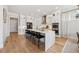 Modern kitchen featuring a large island with seating, stainless steel appliances, and hardwood floors at 4020 Connolly Ct, Roswell, GA 30075