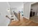 Upstairs landing featuring hardwood floors leading to the laundry room and other bedrooms at 4020 Connolly Ct, Roswell, GA 30075