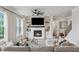 Cozy living room with a fireplace, built-in bookshelves, large windows, and comfortable seating at 4020 Connolly Ct, Roswell, GA 30075