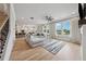 Spacious living room featuring hardwood floors, large windows, and a cozy sectional sofa at 4020 Connolly Ct, Roswell, GA 30075