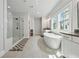 The main bathroom features a glass shower, a soaking tub under a window, and double vanities at 4020 Connolly Ct, Roswell, GA 30075