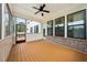 Covered porch with a ceiling fan, brick accents, and large windows, perfect for outdoor relaxation and enjoyment at 4020 Connolly Ct, Roswell, GA 30075