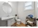 Charming powder room featuring a pedestal sink and stylish decor at 4020 Connolly Ct, Roswell, GA 30075