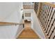 Elegant staircase with wooden steps, black iron spindles, and a light wood handrail for a modern design at 4020 Connolly Ct, Roswell, GA 30075