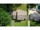 Bird's eye view of a home with an expansive roof and backyard lawn in a tree-lined neighborhood at 1177 Castle Way Way, Norcross, GA 30093